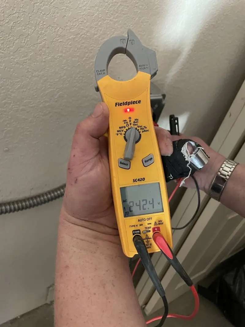 Voltage testing with clamp meter during Outlet Installation in Gulf Breeze